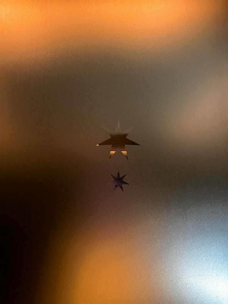 Two stars on a milky glass door