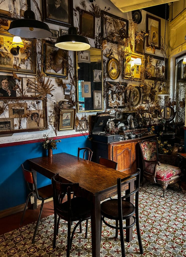 Table and wall with many frames at cafe in Bangkok