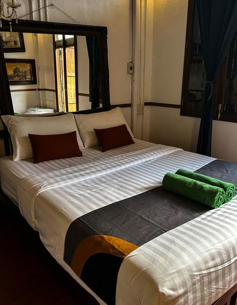 Bed at 103 Bed and Brews with green towels