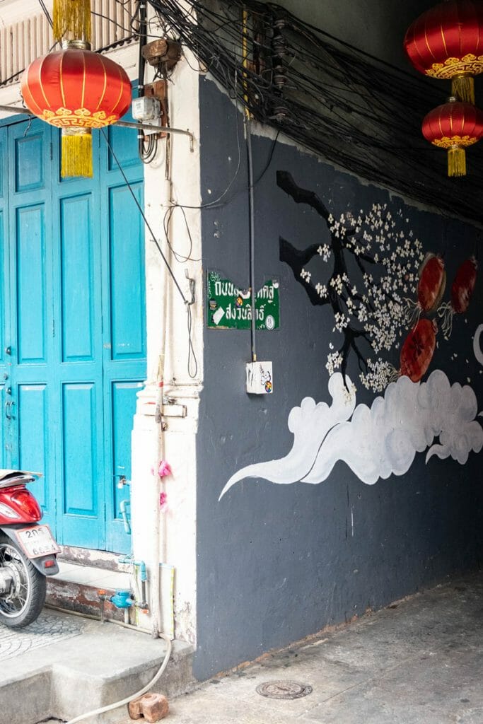 Mural in Chinatown with lantern and blue door