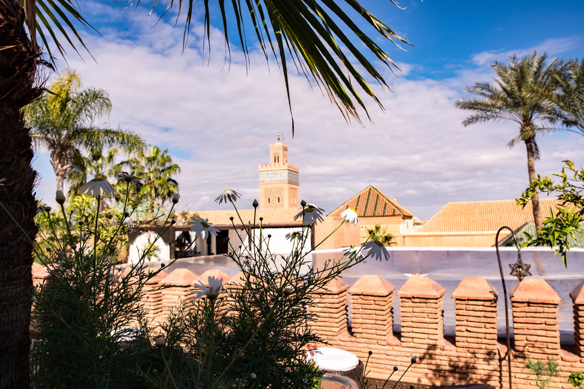 View over Marrakech with mosque and palm trees from La Sultana