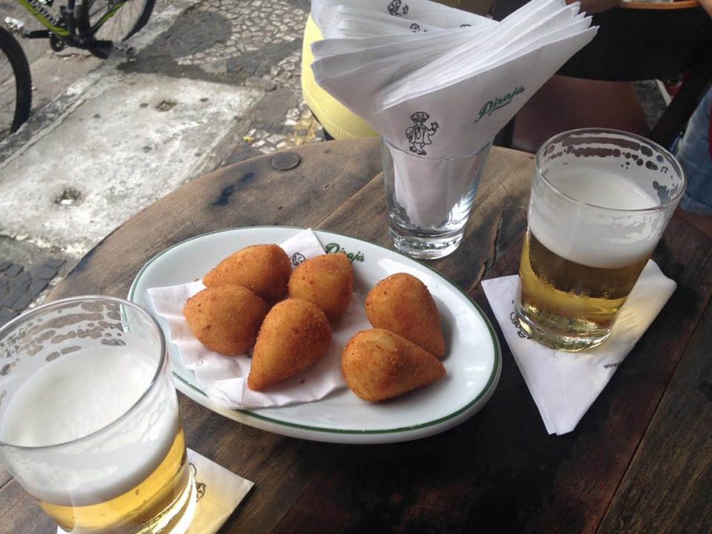 Brazilian Coxinha on a plate with beer