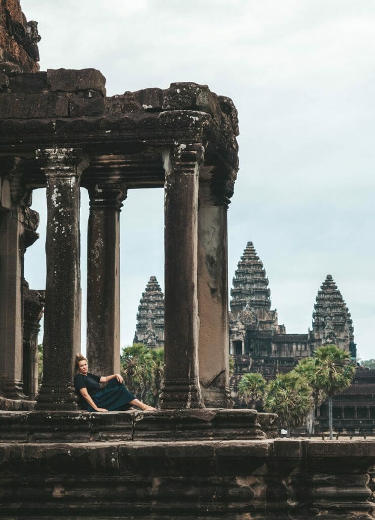 Annika Ziehen sitting next to a column at Angkor wat