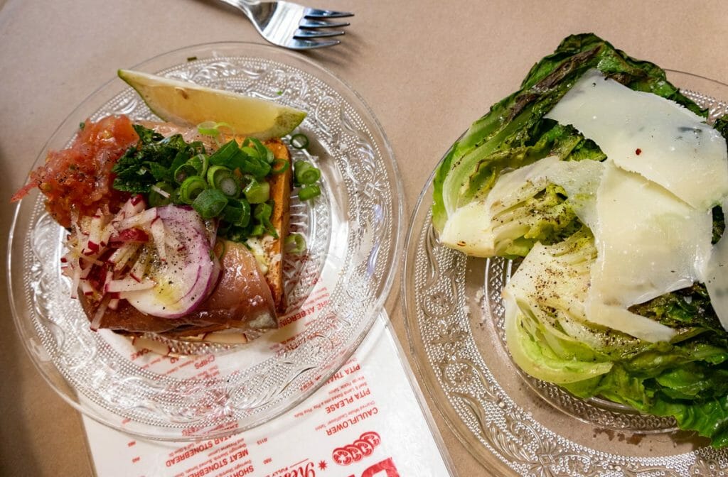 two clear plates with food at blondie bar in cape town