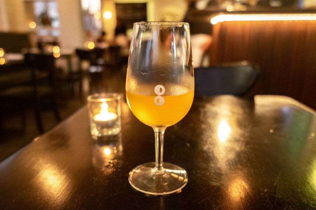 Wine glass on a black table at Mosto